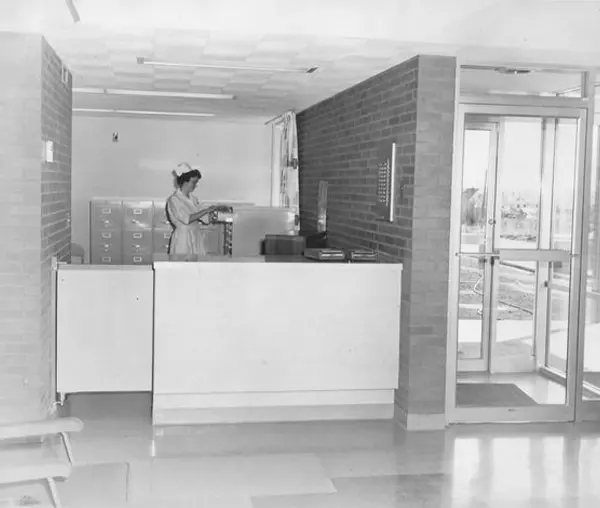 A woman standing in front of a counter.