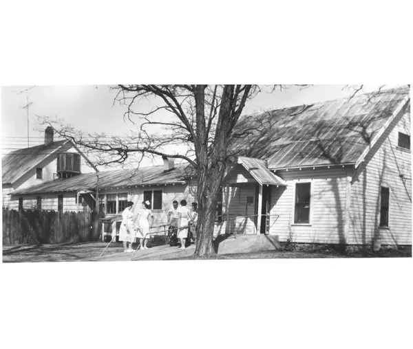 A black and white photo of an old house