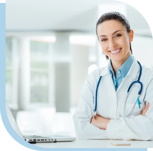 A woman doctor standing in front of a laptop.