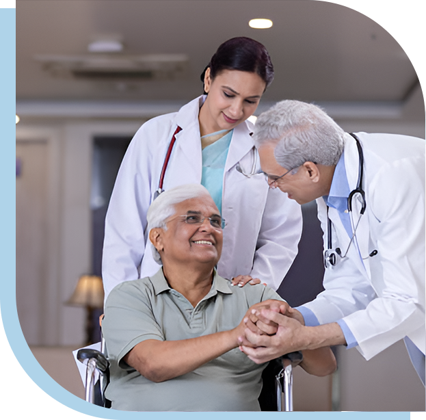 A doctor and two nurses are holding hands with an older man.